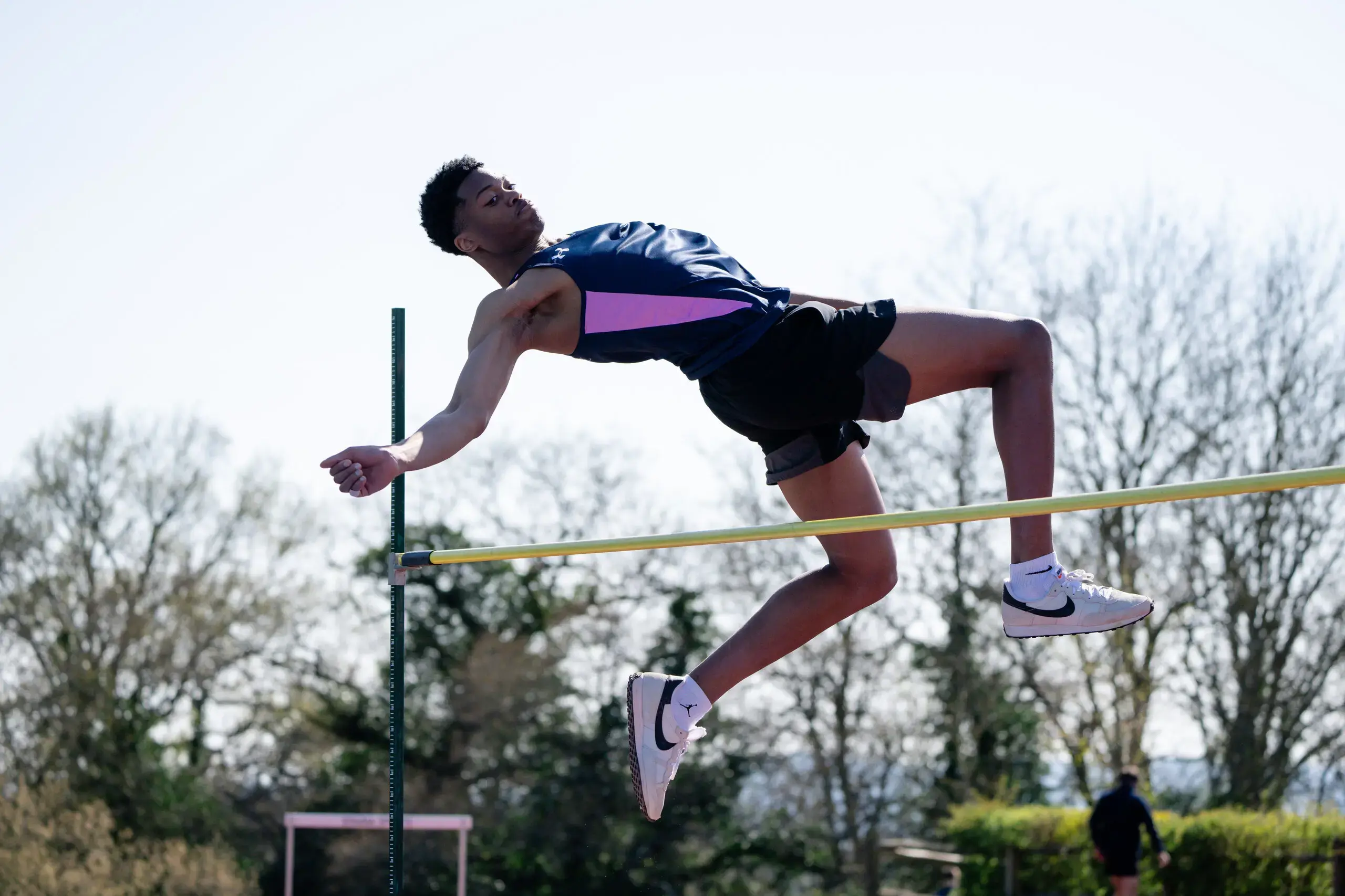 Student athlete executing a high jump