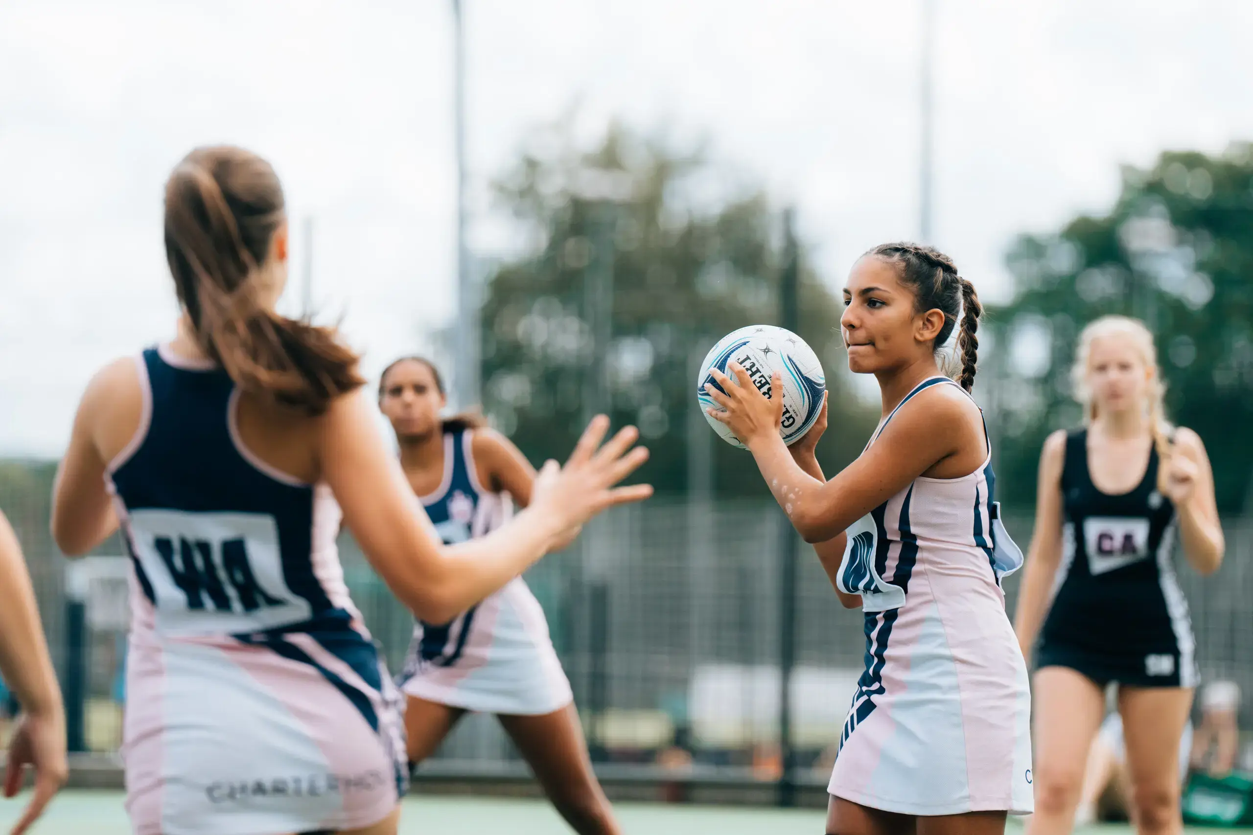 Student athletes playing netball outdoors