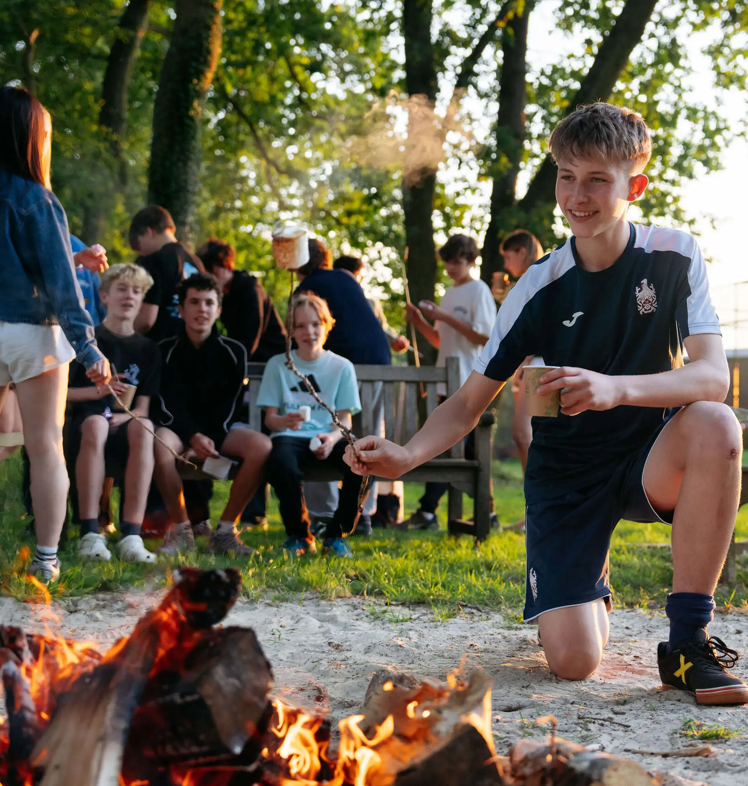 Students surrounding a campfire