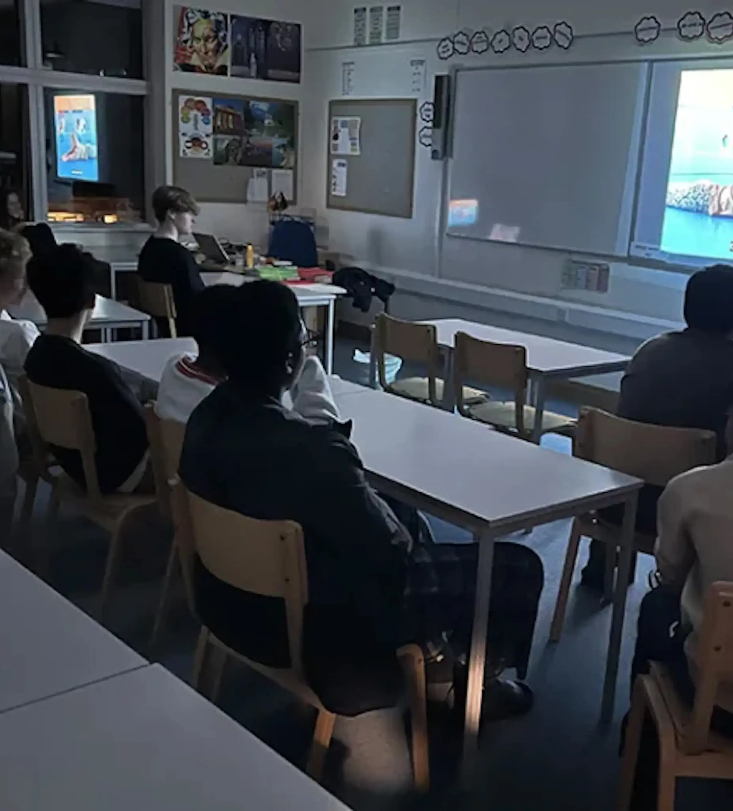 Students watching a video in a classroom