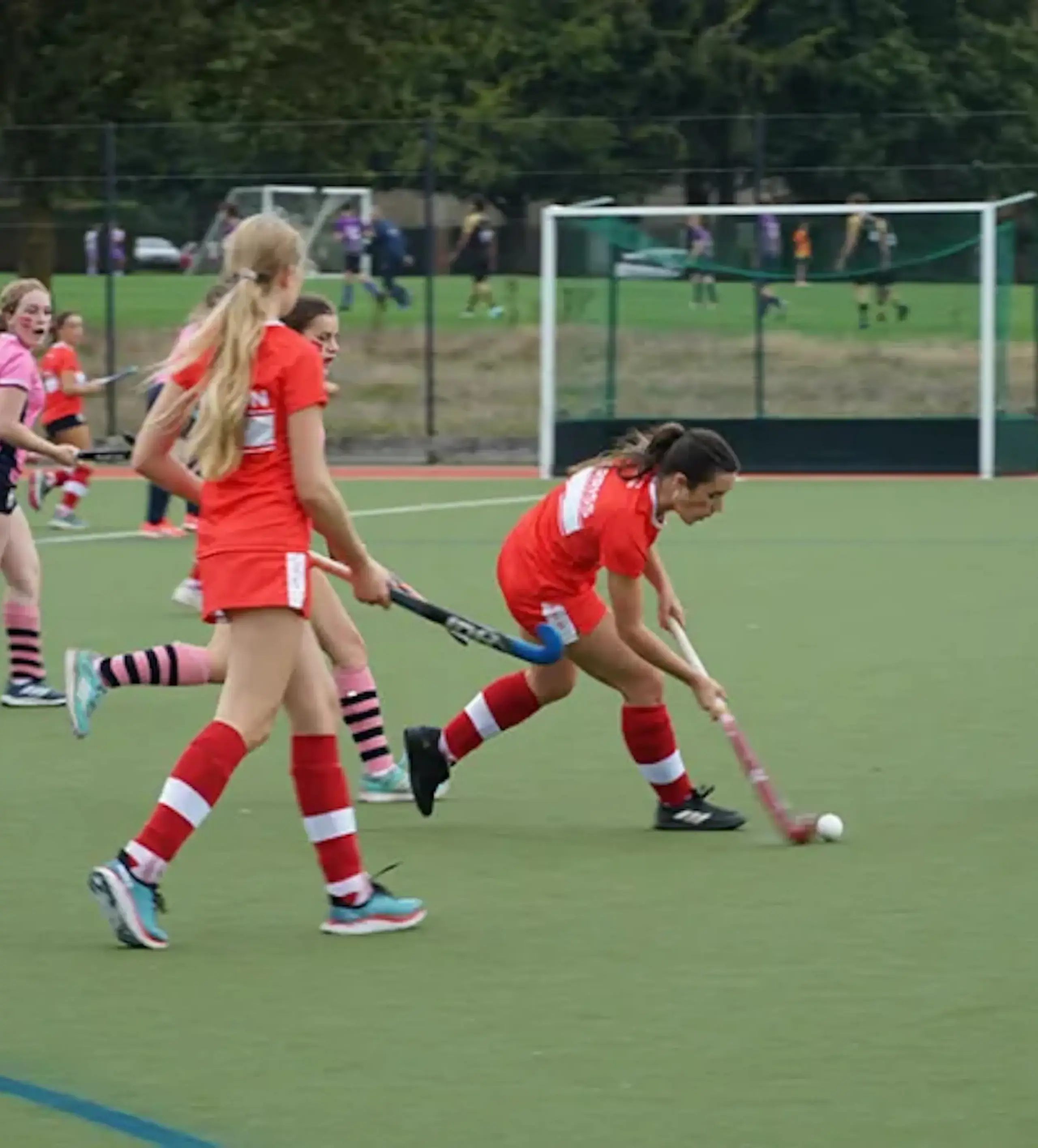 Students playing hockey outside